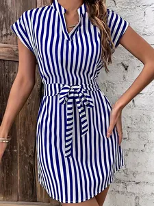 Close-up of blue and white striped mini dress with batwing sleeves and matching waist belt