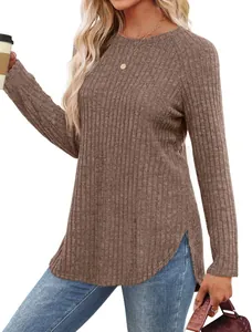 Detailed view of a woman wearing a brown ribbed long sleeve top with curved hemline