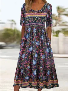 Detail showing the full silhouette and floral pattern of the bohemian maxi dress