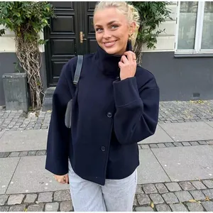 Elegant navy blue high-collar woolen jacket for women worn by model in urban street