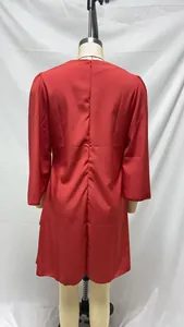 Rear view detail of an elegant red long-sleeve satin dress with invisible zipper.