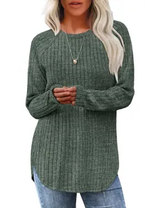 Close-up detail of green ribbed texture and curved high-low hem on long-sleeved sweater