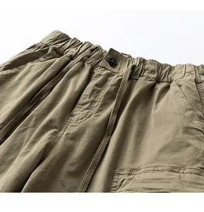 Detailed view of khaki cotton cargo shorts waist with drawstring and elastic band