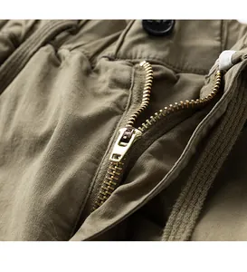 Detailed view of the durable metal zipper on men's cotton cargo shorts in khaki color