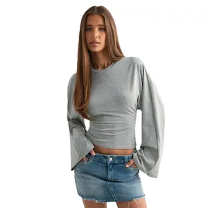 Elegant women's grey round neck long sleeve top with flared sleeves and cinched waist.