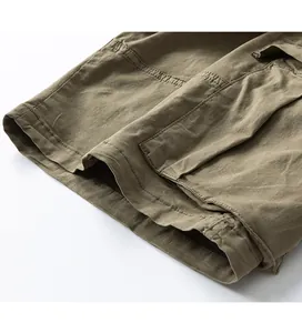 Detailed view of the hem stitching and cotton fabric texture on men's cargo shorts.