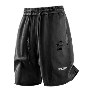Close-up of distressed black sports shorts with white SPRCJEOT lettering