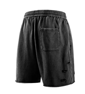 Vintage washed black athletic shorts with distressed hole details and one back pocket.