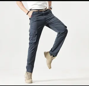Detailed view of dark grey multi-pocket cargo pants for men in retro outdoor studio shot.