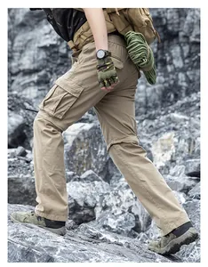 Durable men's functional cargo pants with multiple pockets in an outdoor rocky setting
