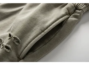 Macro view showing the side pocket and distressed fabric texture of men's cargo shorts.