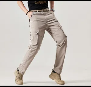 Detailed view of men's khaki multi-pocket cargo pants in a retro outdoor mountain style fit.
