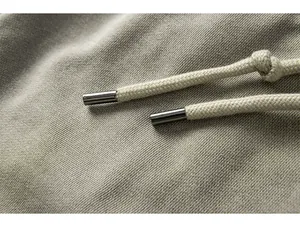Macro detail of high-quality woven drawstring with metal tips on men's cargo shorts
