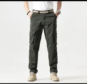 Outdoor mountain style dark green cargo pants with multiple pockets shown on a male model