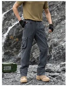 Detailed view of men's loose dark grey cargo pants with functional utility pockets