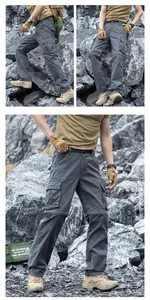 Men's loose grey functional cargo pants with multi-pockets in rugged outdoor environment