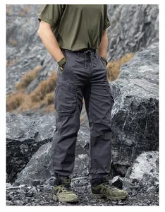 Men's Japanese techwear cargo pants with multiple pockets in an outdoor rocky setting.