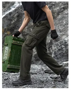 Detailed side view of loose-fit olive green multi-pocket cargo pants in a rugged outdoor setting.