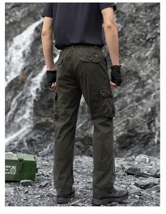 Back view of men's loose olive green multi-pocket cargo pants in outdoor rock setting