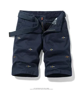 Detailed view of men's vintage navy blue cargo shorts featuring bee embroidery and a belt
