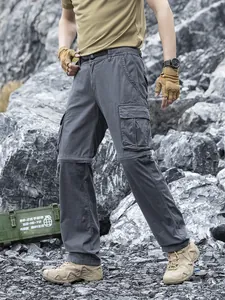 Men's loose Japanese techwear cargo pants with multi-pockets in outdoor rocky terrain