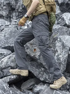 Men's loose grey techwear cargo pants with multi-pocket design for outdoor activities.