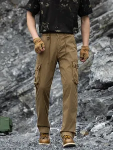 Men's loose techwear cargo pants with multiple pockets in khaki rugged outdoor setting