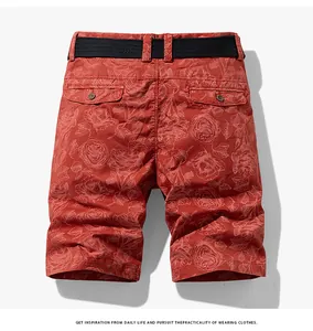 Detailed macro shot of men's red floral cargo shorts featuring back pockets and black belt.