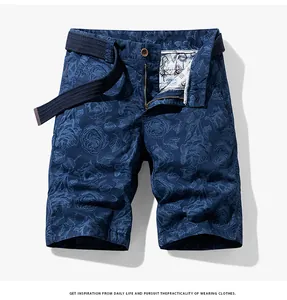 Detail of navy blue floral print cargo shorts with matching belt and zipper fly.