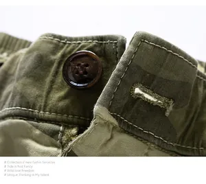 Macro detail view of men's vintage camouflage cargo shorts showing button and durable stitching