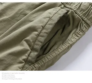 Close-up detail of olive green cargo shorts showing durable pocket stitching and fabric texture.