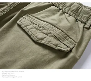 Detail view of olive green cargo shorts featuring an elastic waistband and back pocket flap.