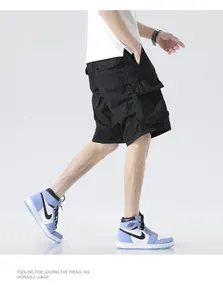 Detailed side view of men's black loose-fit cargo shorts with multiple utility pockets