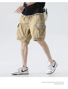 Detailed macro view of men's summer loose khaki cargo shorts with multi-pocket design