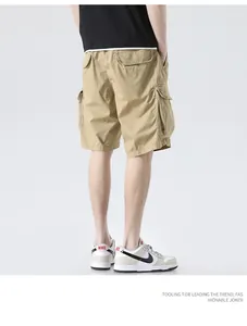 Close-up detail of men's khaki cargo shorts with multi-pocket design and a relaxed fit