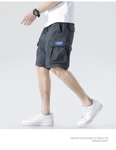 Macro detail showing side view of men's charcoal grey multi-pocket cargo shorts for summer.