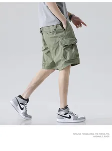 Detail view showing the loose fit and multi-pocket design of men's olive green cargo shorts