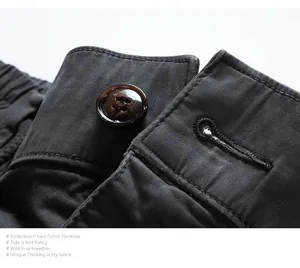 Close-up macro detail of the waist button and durable stitching on men's cargo joggers