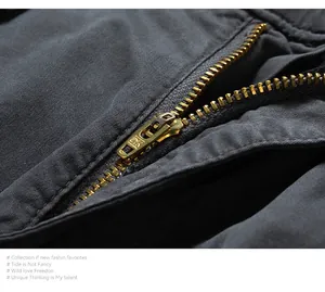 Macro detail view of durable brass metal zipper on men's vintage cargo jogger pants