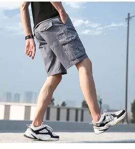 Close-up of men's grey cotton cargo shorts with functional side pockets.