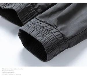 Close-up detail of elastic leg opening on grey men's vintage cargo jogger trousers