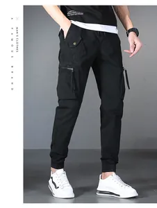 Detail view of men's black cargo pants featuring multi-pockets and cuffed ankles