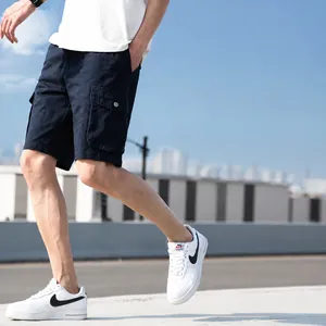 Men's navy blue cotton cargo shorts with multiple pockets and a loose outdoor fit