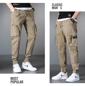 Detail shot of men's khaki cargo joggers with multiple pockets and drawstring waist.