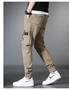 Detailed side view of khaki multi-pocket cargo pants for men with elastic cuffs
