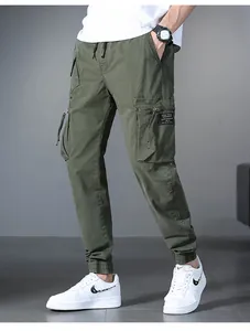 Stylish olive green drawstring cargo pants with functional multi-pocket design for men