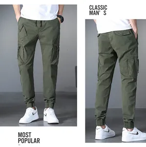 Detailed view of men's olive green multi-pocket cargo joggers with drawstring.