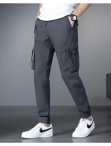 Detailed view of men's grey cargo jogger pants featuring multiple utility pockets