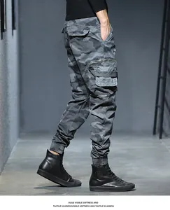 Side view detail of men's vintage camouflage cargo pants with multi-pocket design.