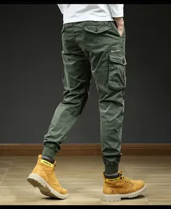 Back view of men's outdoor vintage cargo joggers in olive green with multi pockets